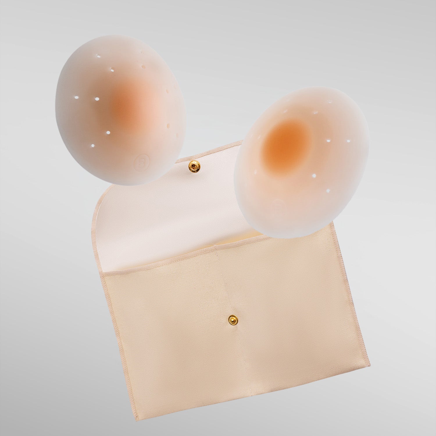 Pair of nude Essential petals in fair shade with breathe points and adhesive-free center and storage pouch.